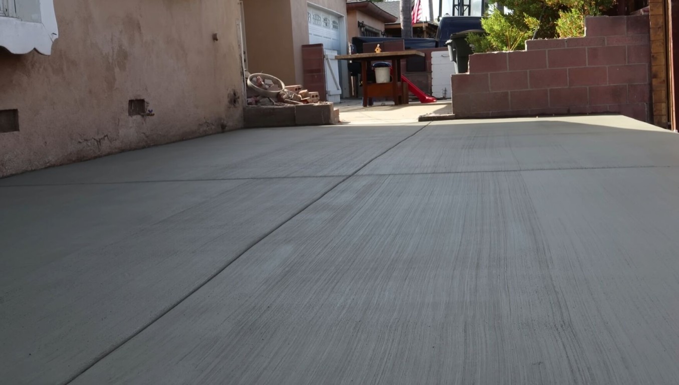 Newly poured concrete sidewalk installation at a residential property in Cupertino, CA