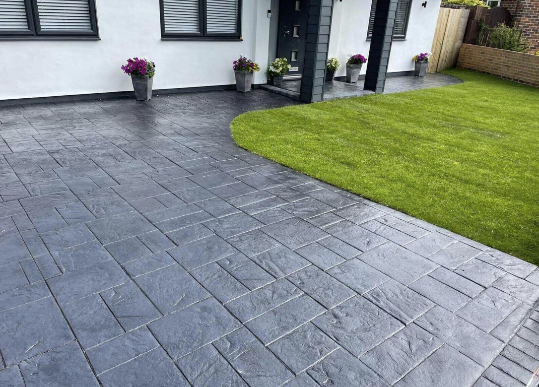 Finished dark gray stamped concrete patio with slate pattern at a modern home in Cupertino, CA